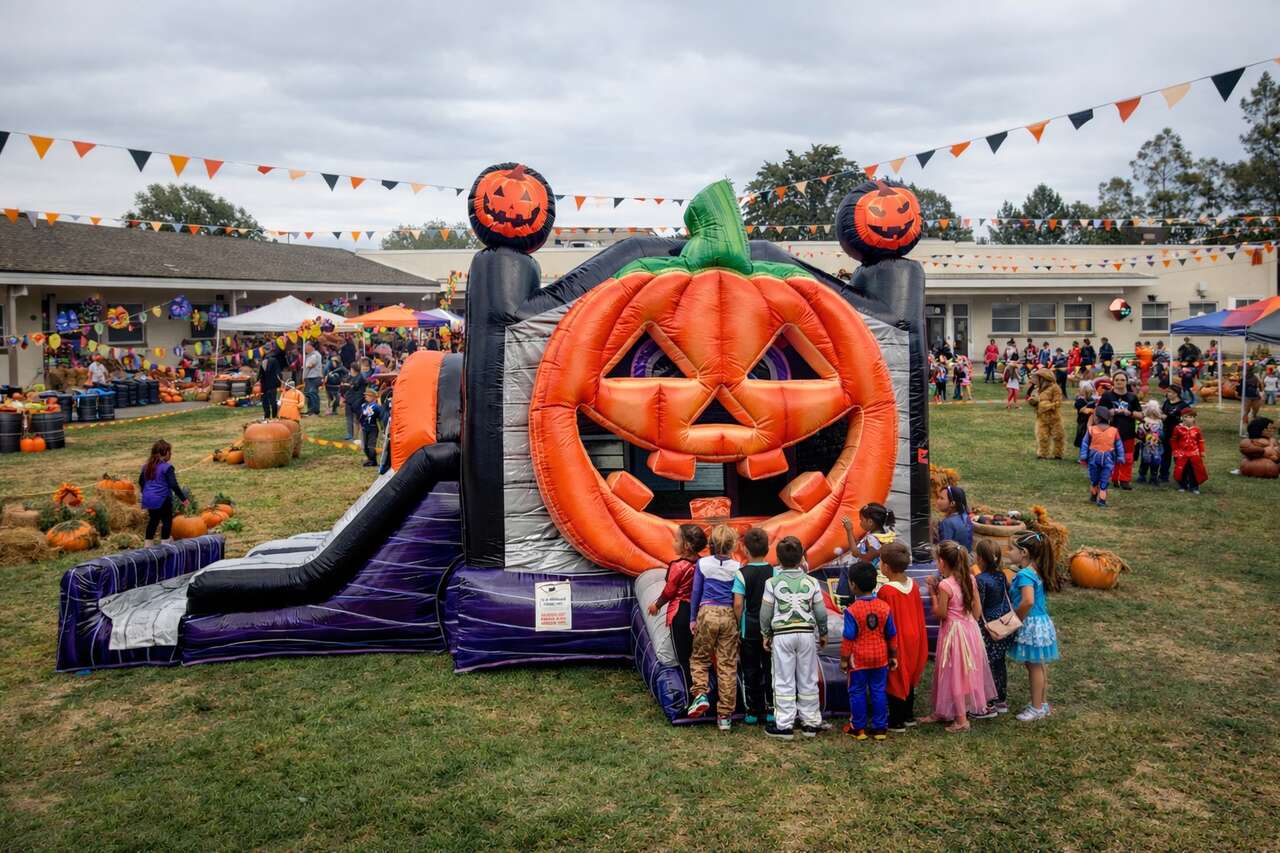 Pumpkin-themed bounce house for school fall festival in Anaheim