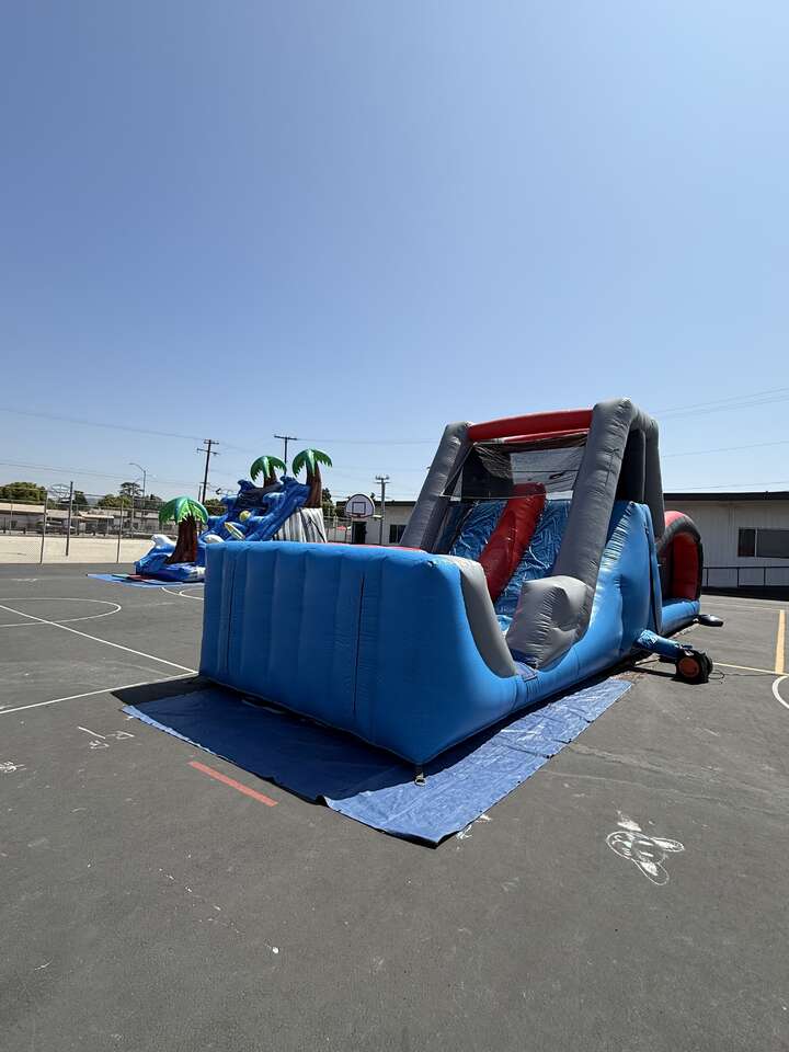 Jump With Chris inflatable dry slide and obstacle course at Long Beach field day