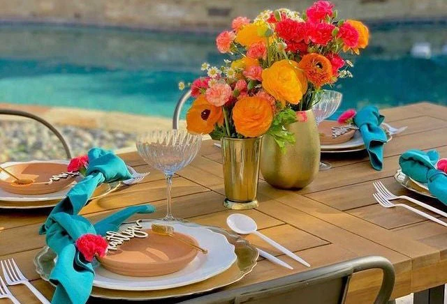 Colorful outdoor table setting by pool