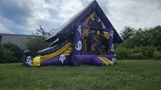 Spooky mansion bounce house with slide