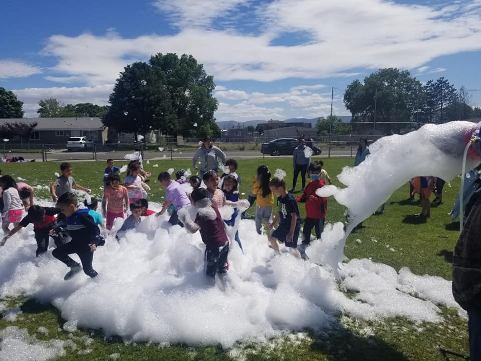 a group of kids having a foam party.