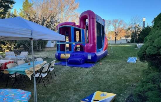 Keystone Bounce outdoor party rental setup with bounce house, tent, and tables