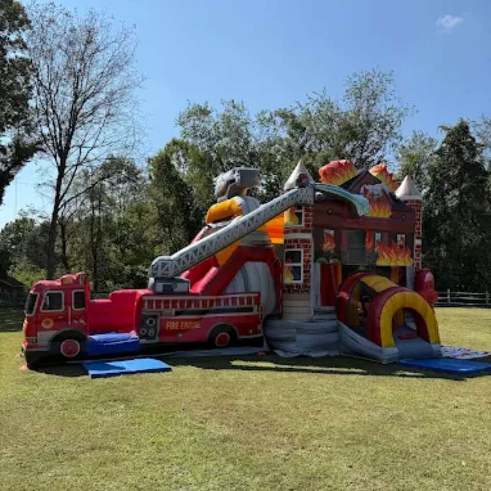 Keystone Bounce Fire House Combo Wet or Dry inflatable set up on a grass lawn