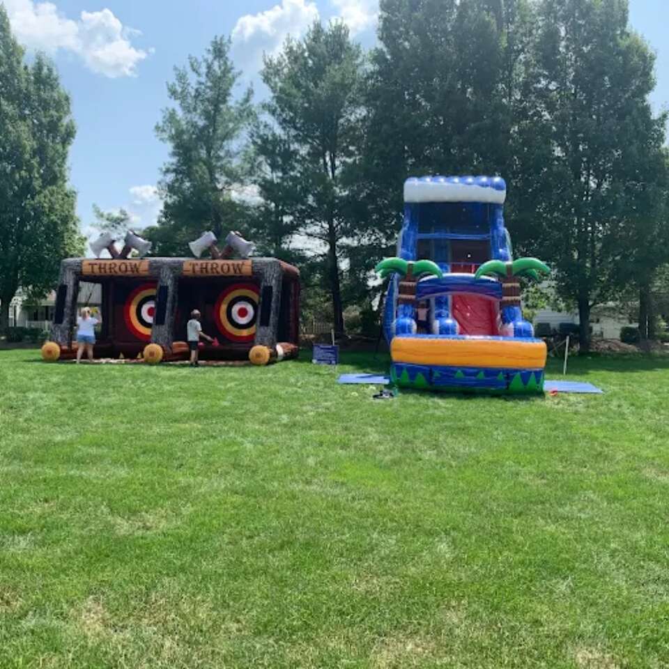 Multiple Keystone Bounce inflatable rentals set up at an outdoor party venue