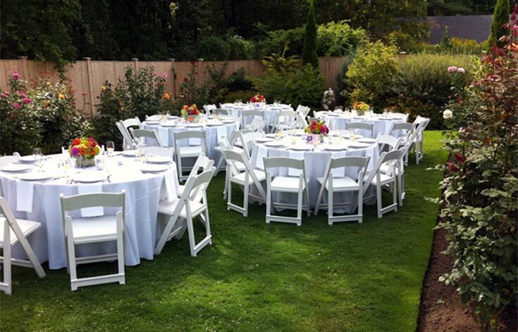 Elegant outdoor setup with chairs and tables arranged for an event by Exclusive Event Rentals Elegant outdoor setup with chairs and tables arranged for an event by Exclusive Event Rentals