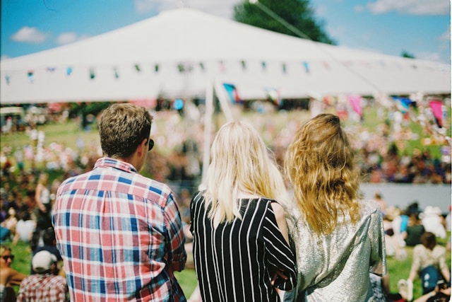 Three people attending an outdoor church event Three people attending an outdoor church event