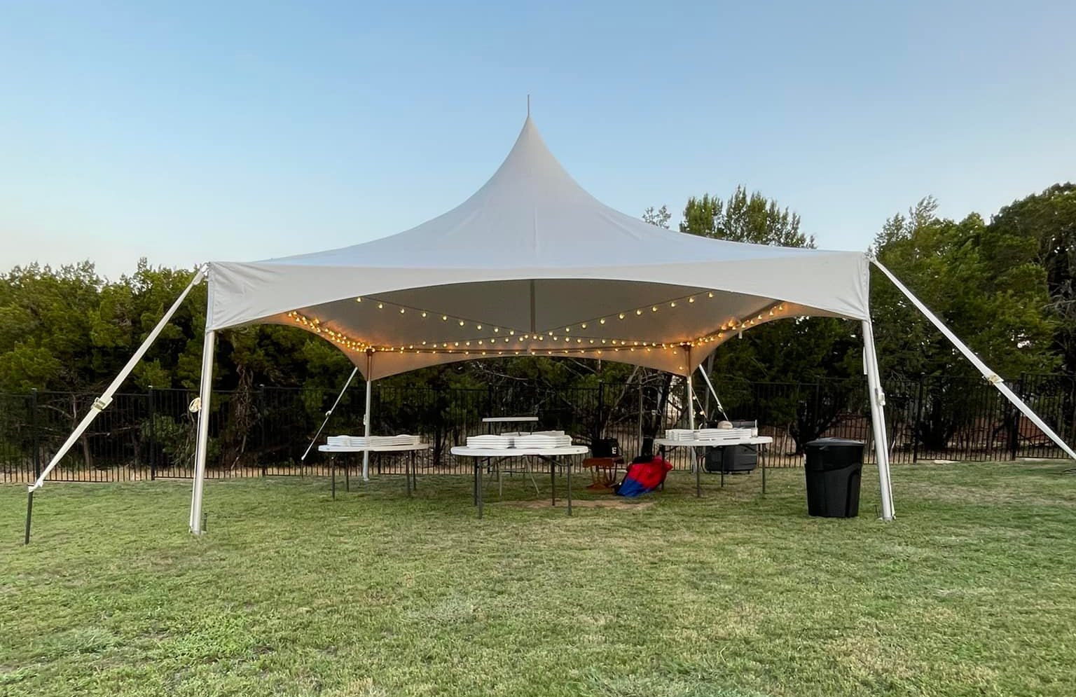 Outdoor party tent setup with chairs and tables by Exclusive Event Rentals Outdoor party tent setup with chairs and tables by Exclusive Event Rentals