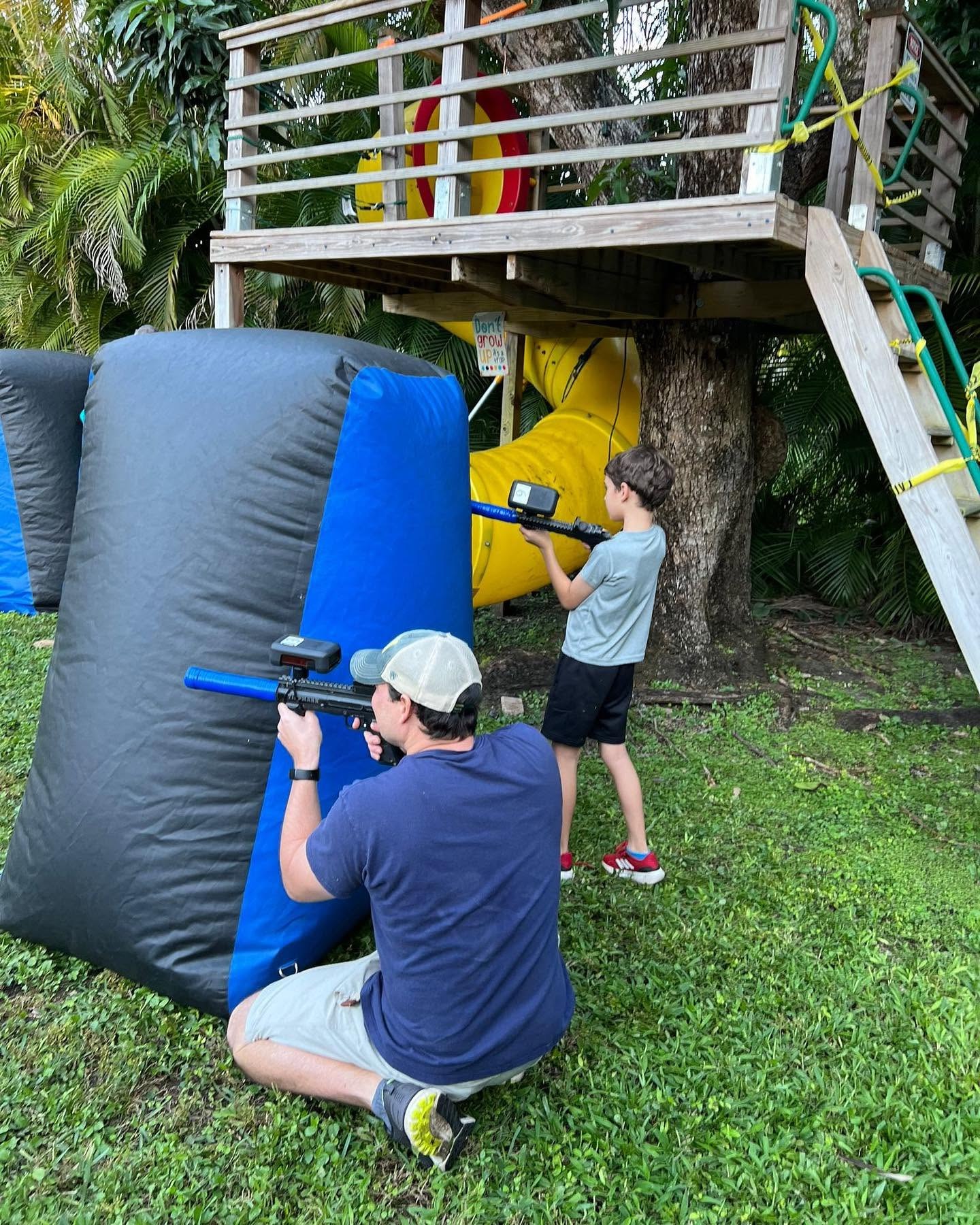 Night laser tag game in a Miami backyard