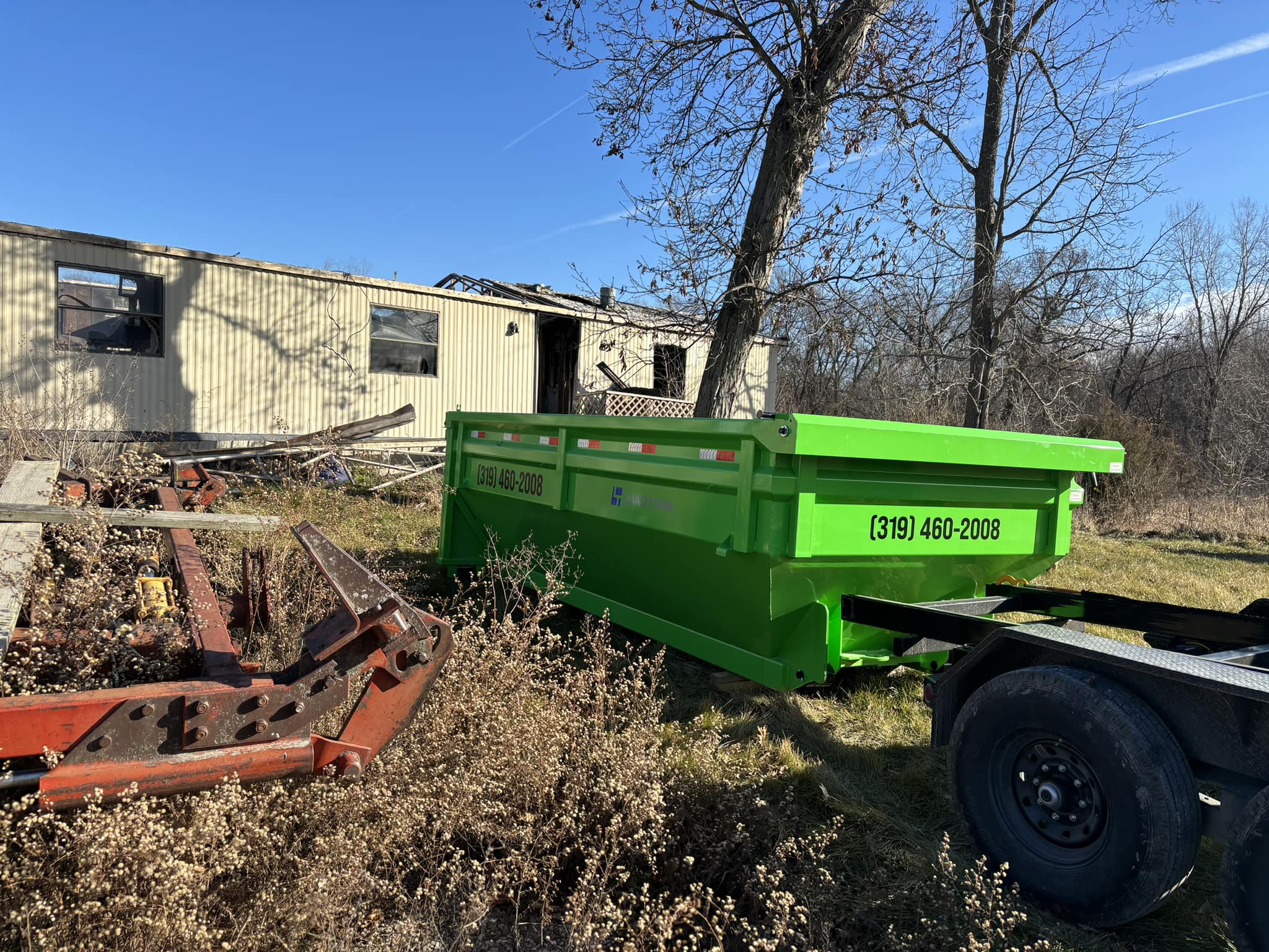 dumpster placed next to a building in a rural area dumpster placed next to a building in a rural area