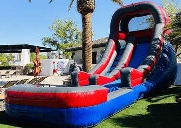 blue water slide set up in a backyard, ready for summer fun and excitement