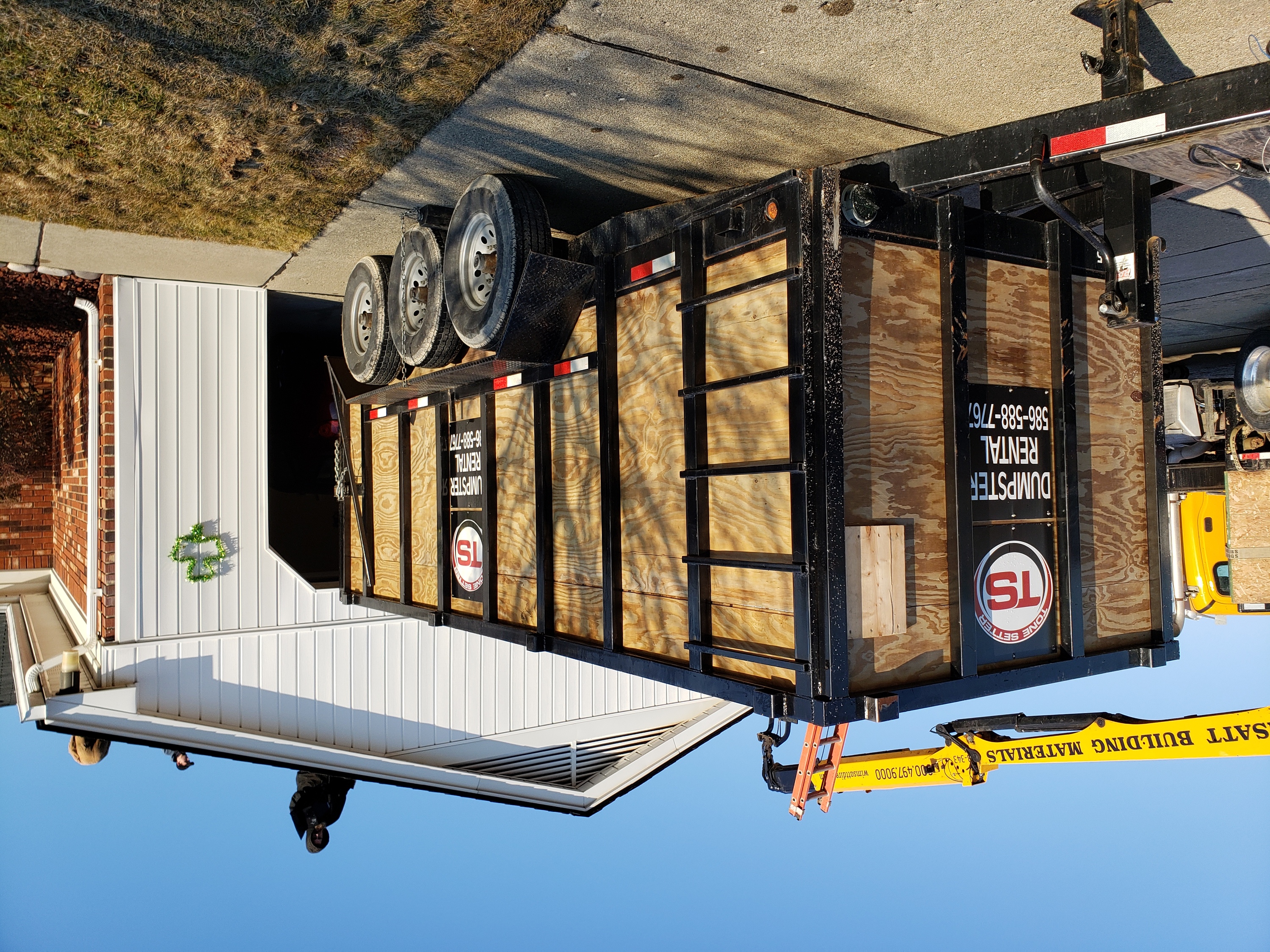 A large dumpster rental trailer parked