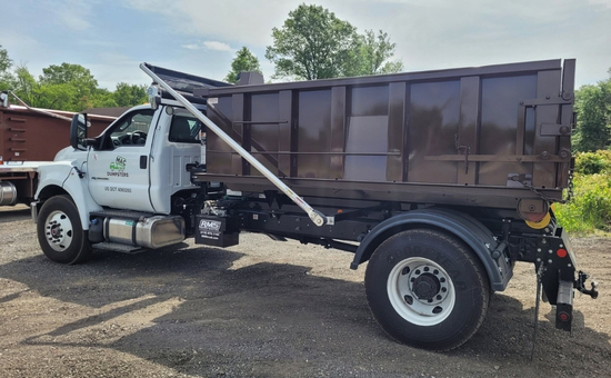 MAC Dumpsters roll-off truck with a raised container in Aberdeen