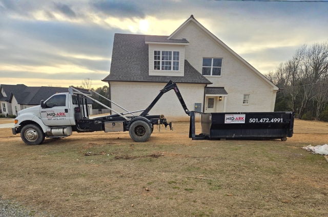 Roll-off dumpster delivery for a residential home by Mid-Ark Dumpsters LLC