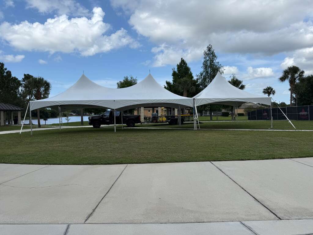Large high peak event tents installed on a Central Florida field