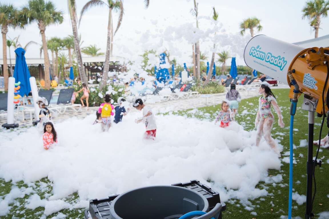 Children enjoying a large outdoor foam party with Millers Jump Time