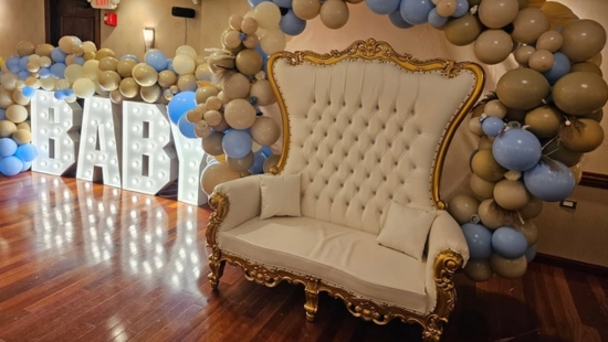 Gold throne chair with BABY marquee letters and balloon arch by Meriden Party Rentals