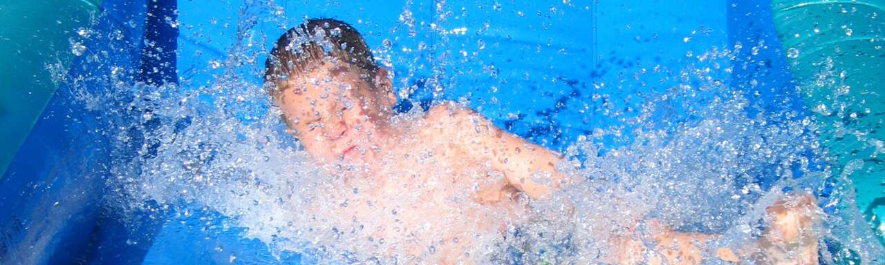 Kids playing on inflatable water slide