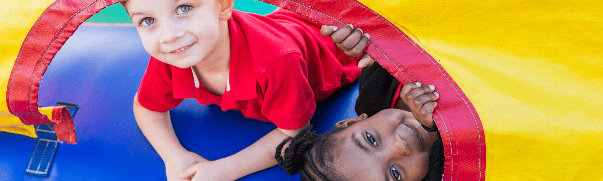 Kids playing inside a colorful bounce house