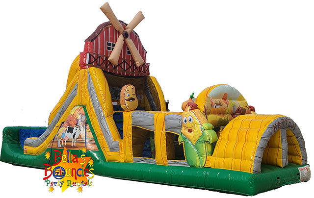 Farm themed inflatable obstacle course with barn, animals, and slide rental from Bella’s Bouncies