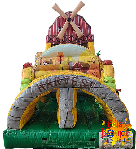 Farm themed inflatable obstacle course with barn, animals, and slide rental from Bella’s Bouncies