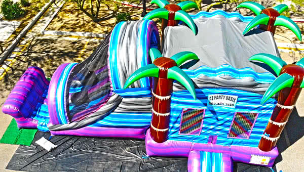 Colorful AZ Party Oasis bounce house and slide setup