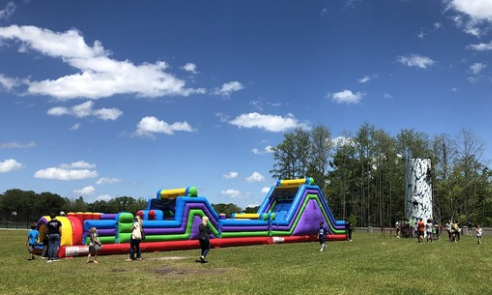 Bounce house rental set up on a lawn by Orlando Fun Bounce.
