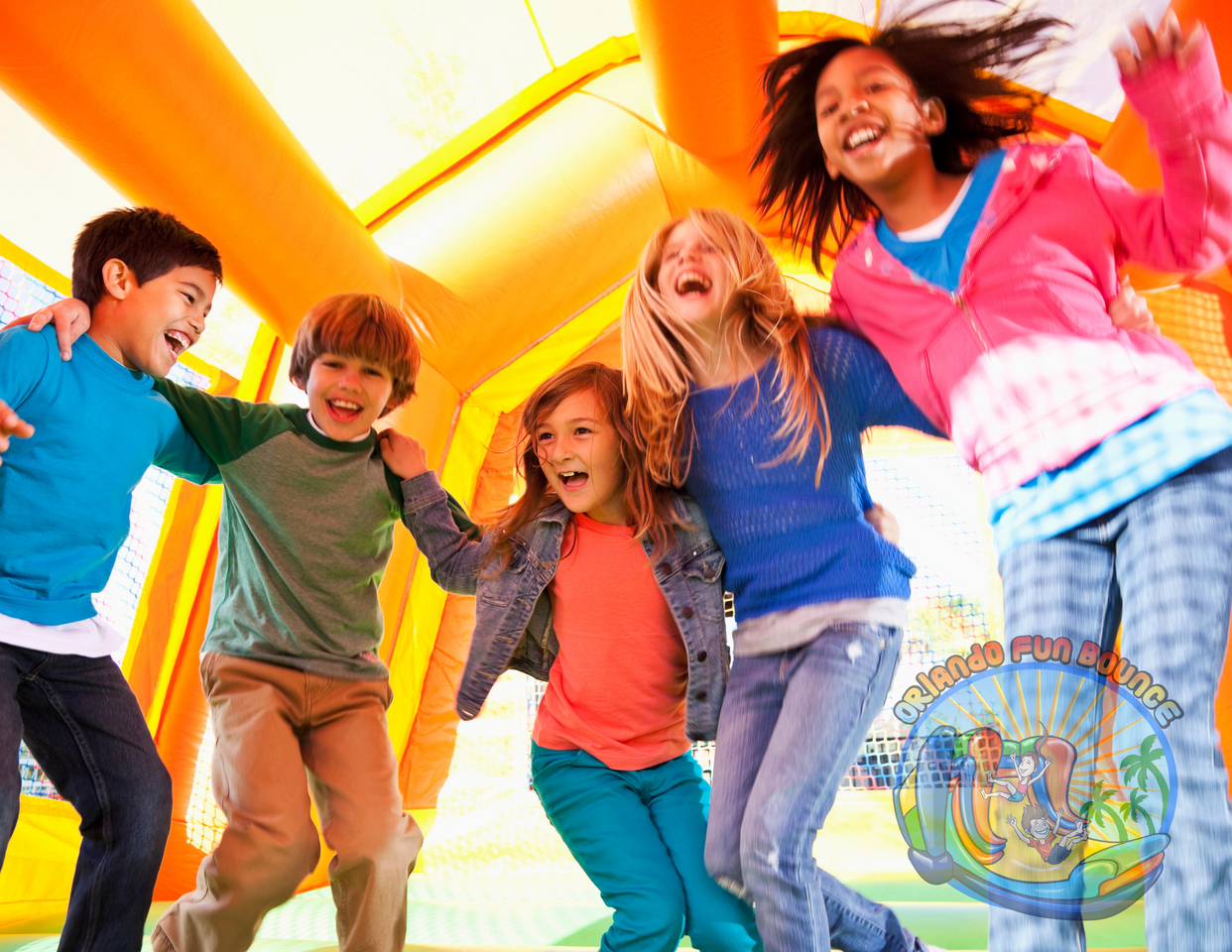 Warehouse view of bounce house rentals, water slides, and tents ready for delivery in Central Florida