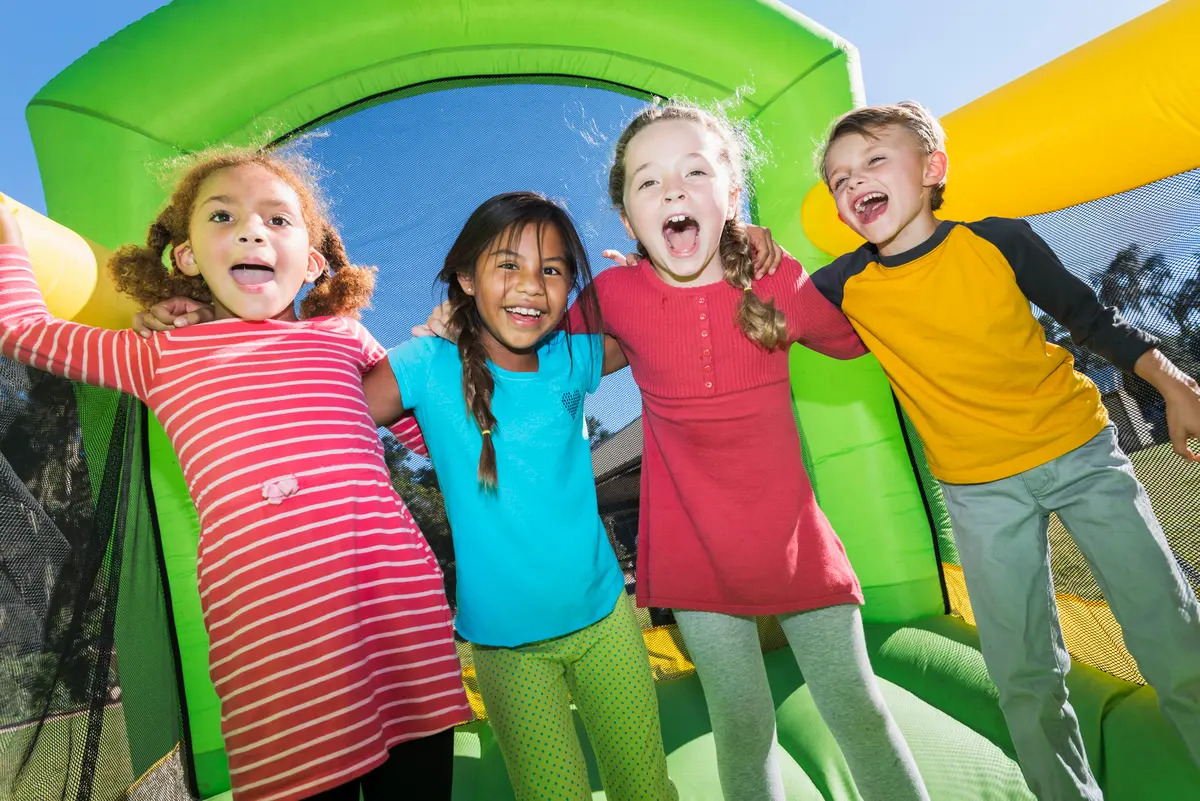 Group of happy children laughing and playing inside a bright inflatable from bounce house rentals in Travelers Rest, SC Group of happy children laughing and playing inside a bright inflatable from bounce house rentals in Travelers Rest, SC