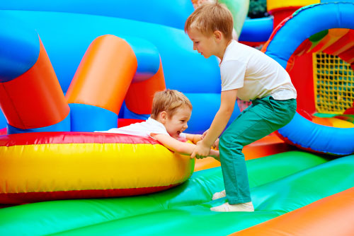 Kids playing and laughing inside a colorful inflatable from bounce house rentals in Fountain Inn, SC