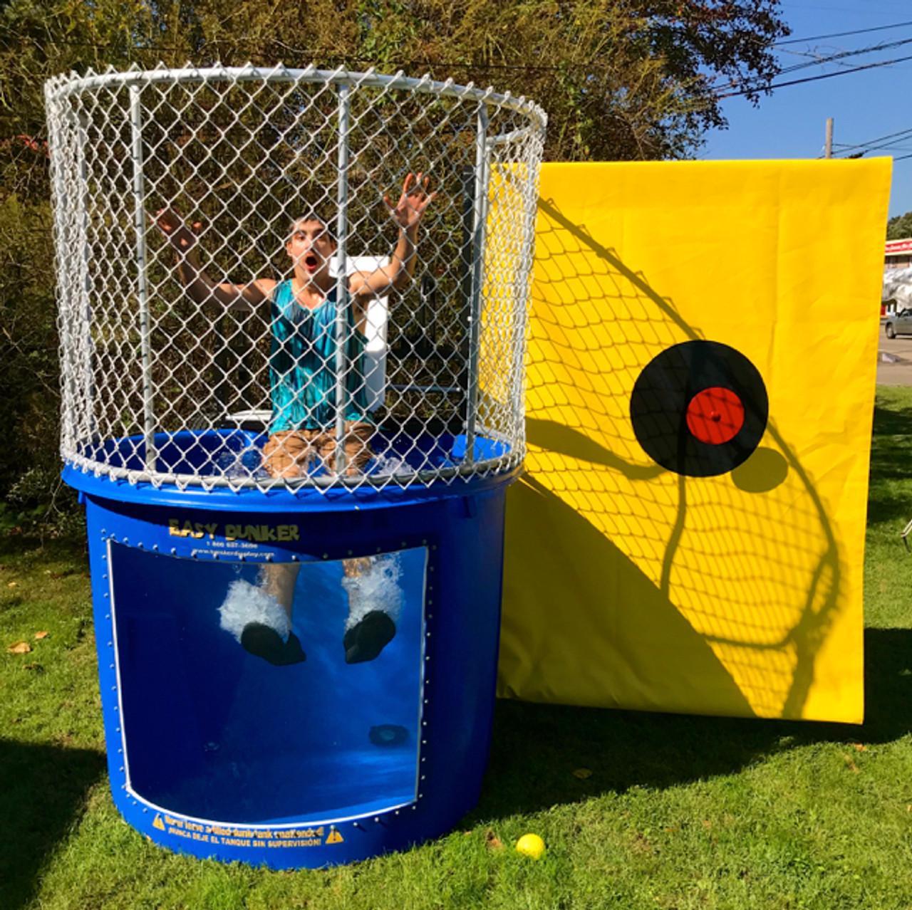 This dunk tank rental in Berea, SC is set up outdoors on grass for a school field day celebration. The blue tank features a clear viewing window and safety cage above, with a bright yellow target backdrop that adds high visibility for throwing. Perfect for school fundraisers, church festivals, corporate picnics, and community events throughout Berea, this dunk tank brings interactive excitement and crowd engagement to any outdoor gathering.