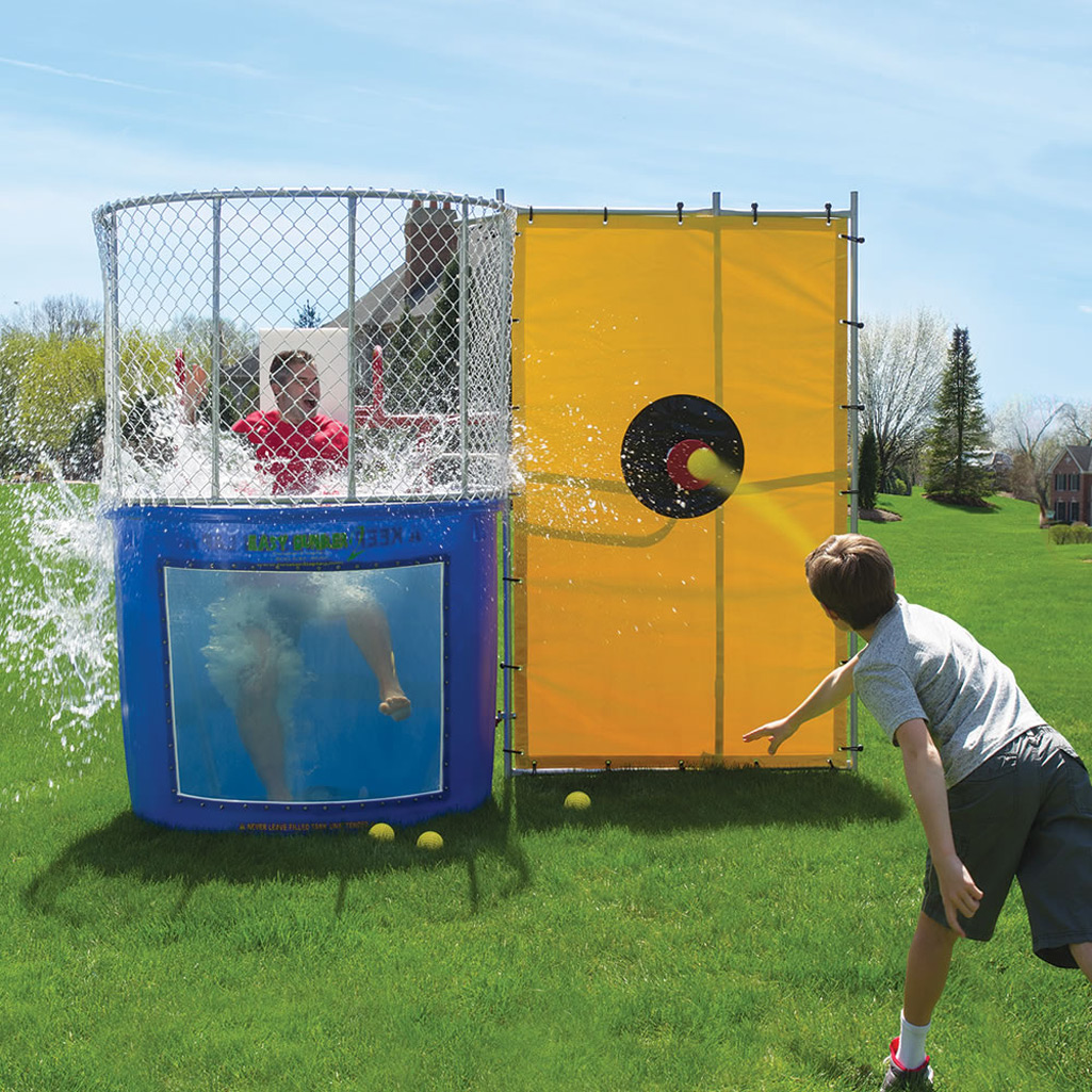 This dunk tank rental in Taylors, SC captures the exciting splash as the target is hit and the participant drops into the water. Set up on a sunny lawn, the blue tank with clear viewing window and bright yellow bullseye backdrop creates a classic carnival-style attraction. Ideal for backyard birthday parties, school field days, church festivals, and neighborhood events throughout Taylors, this dunk tank rental delivers high-energy fun and memorable moments for guests of all ages.