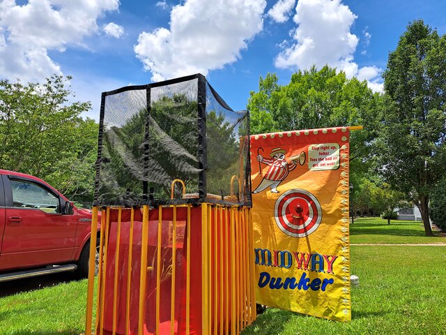 Colorful Midway Dunker tank set up outdoors, showcasing dunk tank rentals in Greenville, SC.