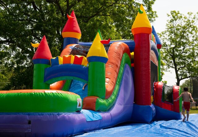 Rainbow Bounce House and Slide Combo rental in Wade Hampton, SC, set up on a sunny day.