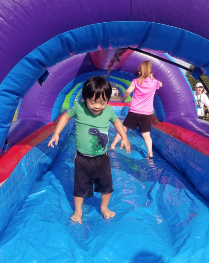Children playing on a colorful inflatable slip-and-slide under the sun, showcasing Water Slide Rentals in Parker, SC for exciting and refreshing summer events. Children playing on a colorful inflatable slip-and-slide under the sun, showcasing Water Slide Rentals in Parker, SC for exciting and refreshing summer events.