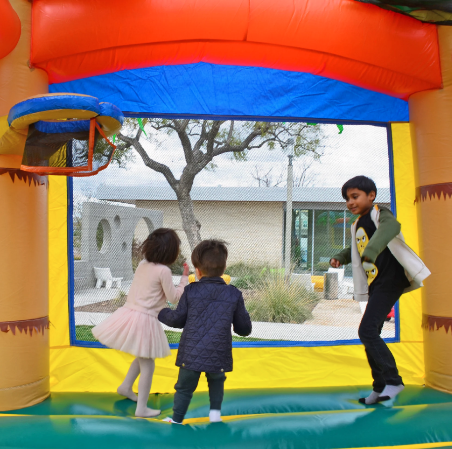 Kids playing together inside a bounce house during a school or church event in Greenville, SC