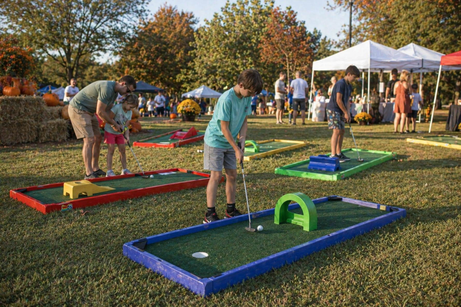 Families playing portable mini golf rentals in Gantt, SC at a fall festival with pumpkins, hay bales, and colorful putting lanes. Mini golf rentals in Gantt, South Carolina are a popular attraction for church festivals, seasonal events, and neighborhood gatherings. This realistic setup brings interactive fun to all ages.
