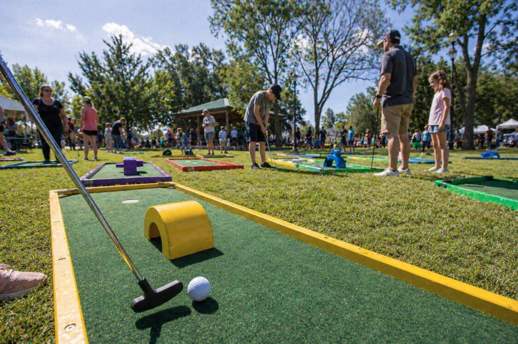 Families enjoying portable mini golf rentals in Berea, SC at a city park family fun day with colorful lanes and outdoor entertainment. Mini golf rentals in Berea, South Carolina are a great option for parks, school events, and community festivals. This realistic rental setup provides fun for kids, teens, and adults alike.