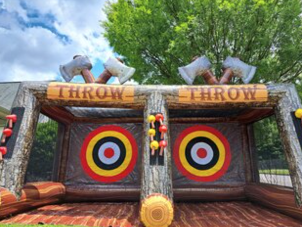 Axe throwing inflatable game with two target lanes, oversized axe decorations, and rustic wood-style graphics.