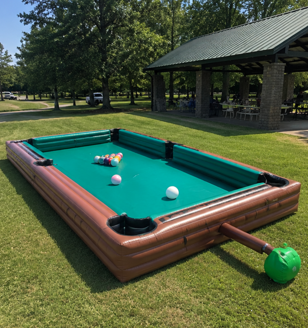 Giant inflatable pool table with oversized billiard balls and cue set up at a park event in Piedmont, SC.