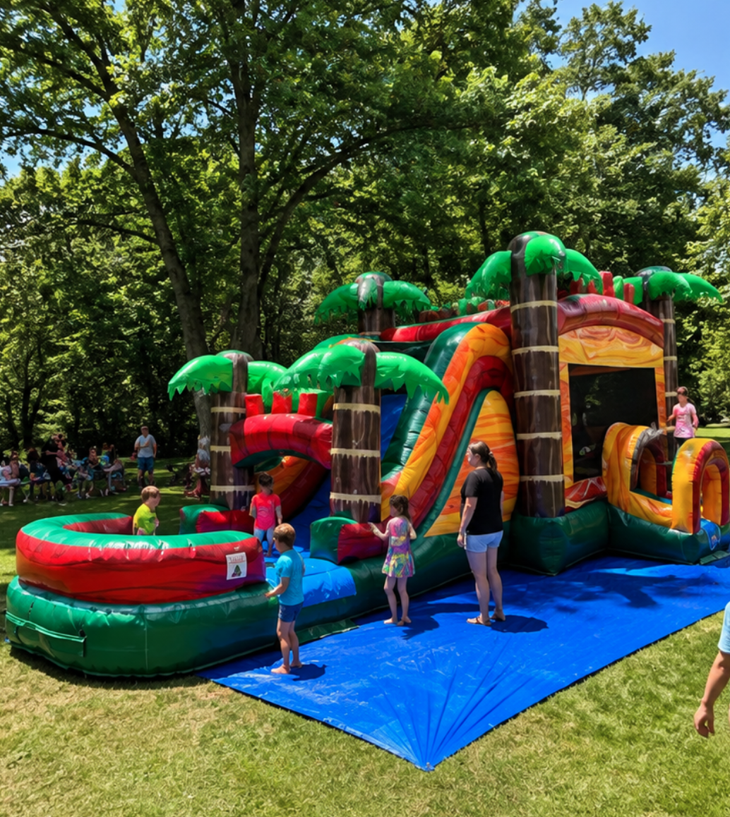 Tropical inflatable bounce house and slide combo at a busy summer event in Greenville, SC, with children playing and adults supervising nearby.