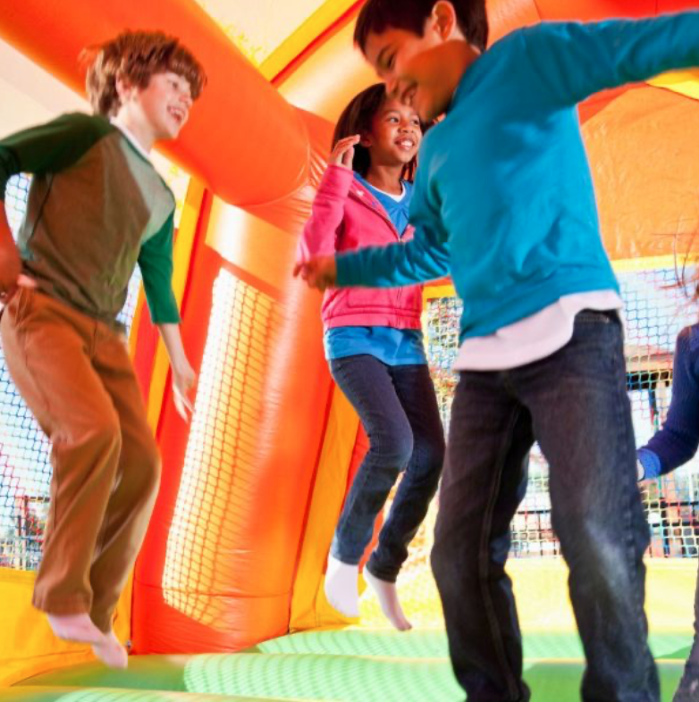 Children jumping and playing together inside a colorful inflatable bounce house, showcasing bounce house rental fun for birthday parties and events in Gantt, SC.