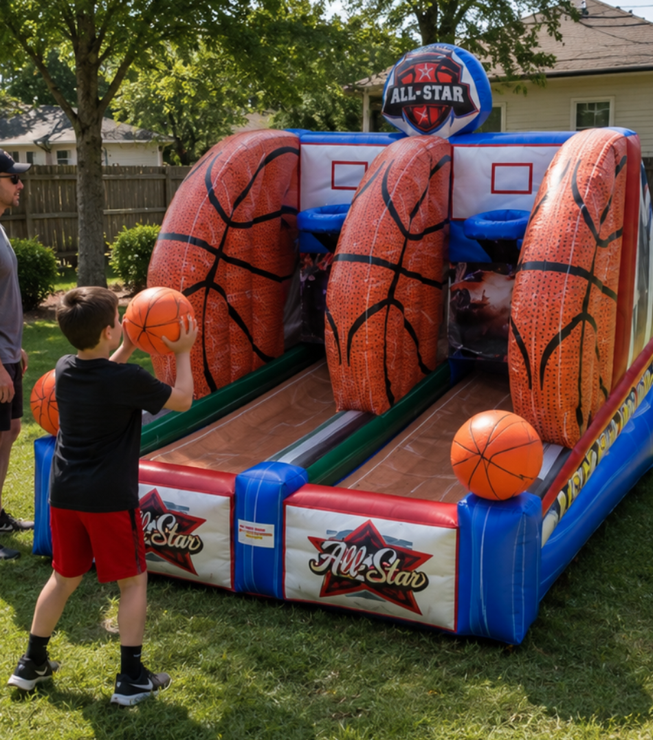  Young boy holding a basketball and aiming at an All-Star inflatable basketball game with two hoops in a grassy backyard.