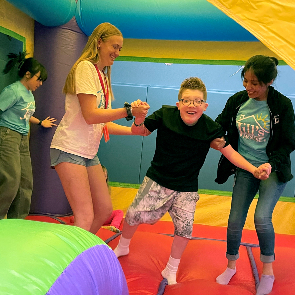 Children enjoying a colorful inflatable during a back-to-school event, featuring Bounce House Rentals in Greenville, S.C., with volunteers helping kids have fun safely. Children enjoying a colorful inflatable during a back-to-school event, featuring Bounce House Rentals in Greenville, S.C., with volunteers helping kids have fun safely.