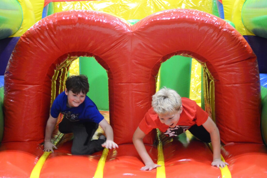 Kids racing through a colorful inflatable obstacle course at a fall festival, showcasing Bounce House Rentals in Greenville, S.C., for fun and active community events. Kids racing through a colorful inflatable obstacle course at a fall festival, showcasing Bounce House Rentals in Greenville, S.C., for fun and active community events.