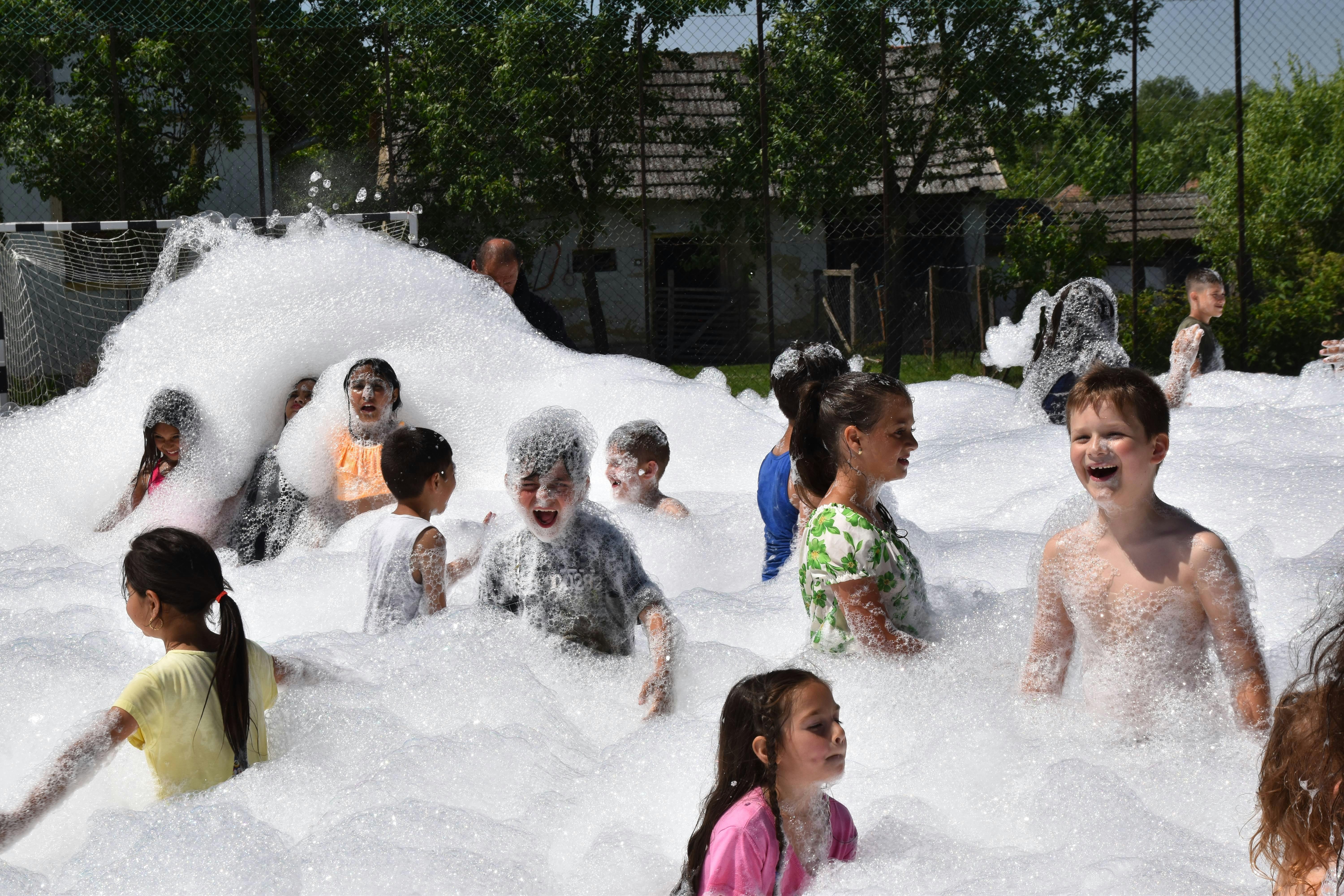 Children laughing and playing in a field of bubbles during Foam Parties in Mauldin, SC. Children laughing and playing in a field of bubbles during Foam Parties in Mauldin, SC.