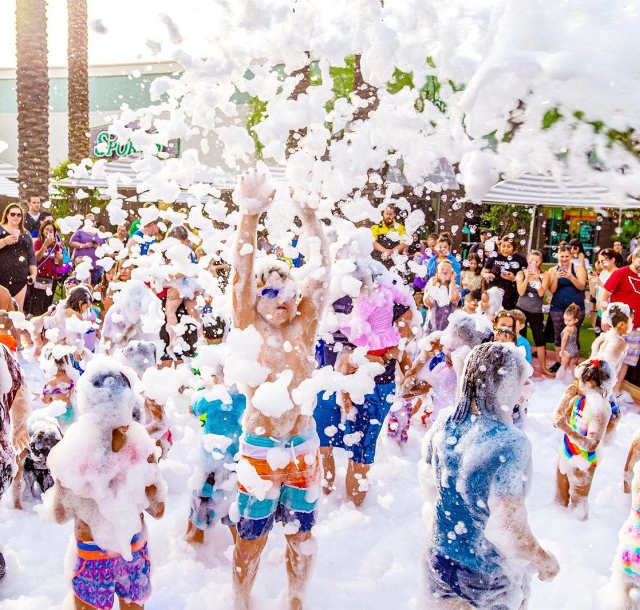 Children and families enjoy a high-energy outdoor foam party with thick bubbles, music, and crowd excitement at a local event in Wade Hampton SC, showing how popular foam party rentals are for birthdays, schools, and neighborhood gatherings.