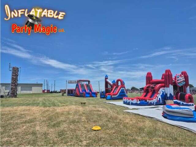 Inflatable water slides and rock climbing wall rental set up at an event in Godley Texas from Inflatable Party Magic