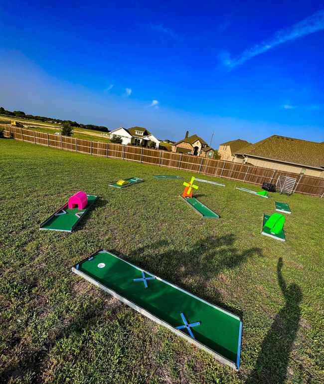 Portable mini golf rental set up for a backyard birthday party in DFW Texas from Inflatable Party Ma…