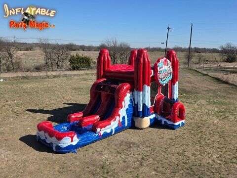 Red White and Cool bounce house with a slide set up for a backyard birthday party rental in Southlak…