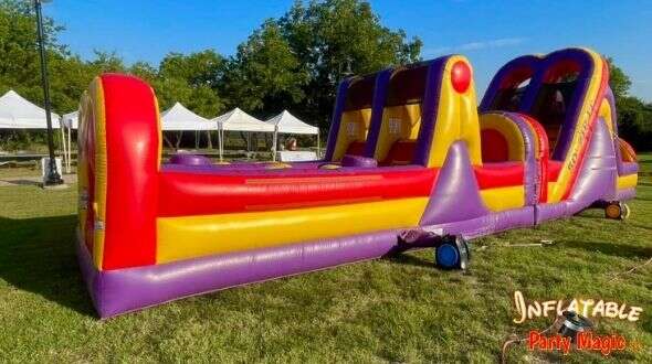 Tips for renting a bounce house in Aledo featuring and obstacle course bounce house in bright primar…